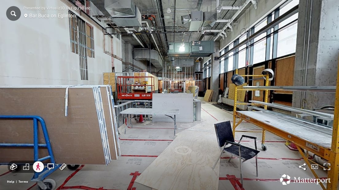 Bar Buca entrance in the first progress scan — open framing, exposed studs, construction equipment on the floor