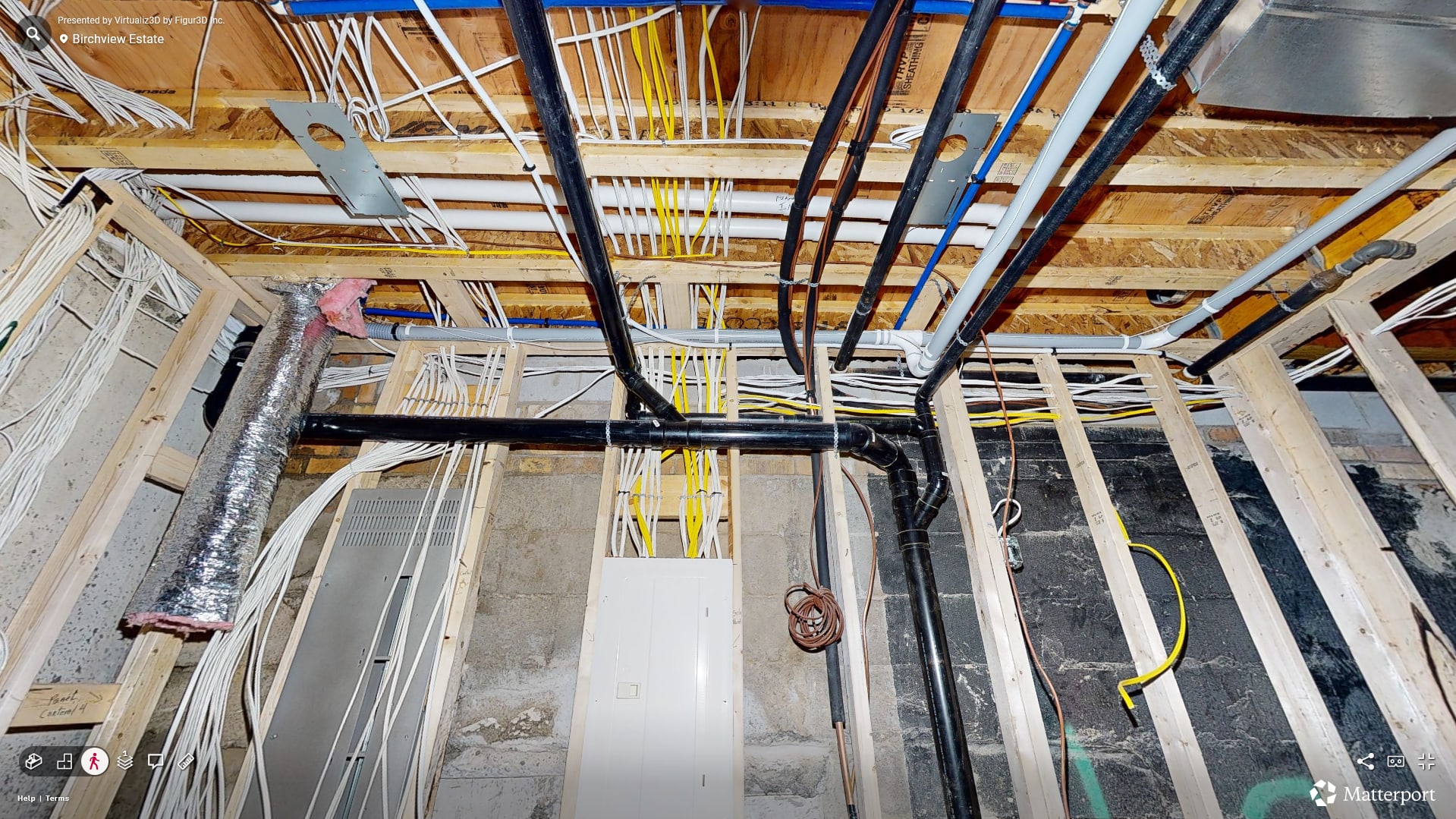 Pre-drywall interior view of the Birchview Estate — open framing, mechanical rough-in, and natural light from large windows